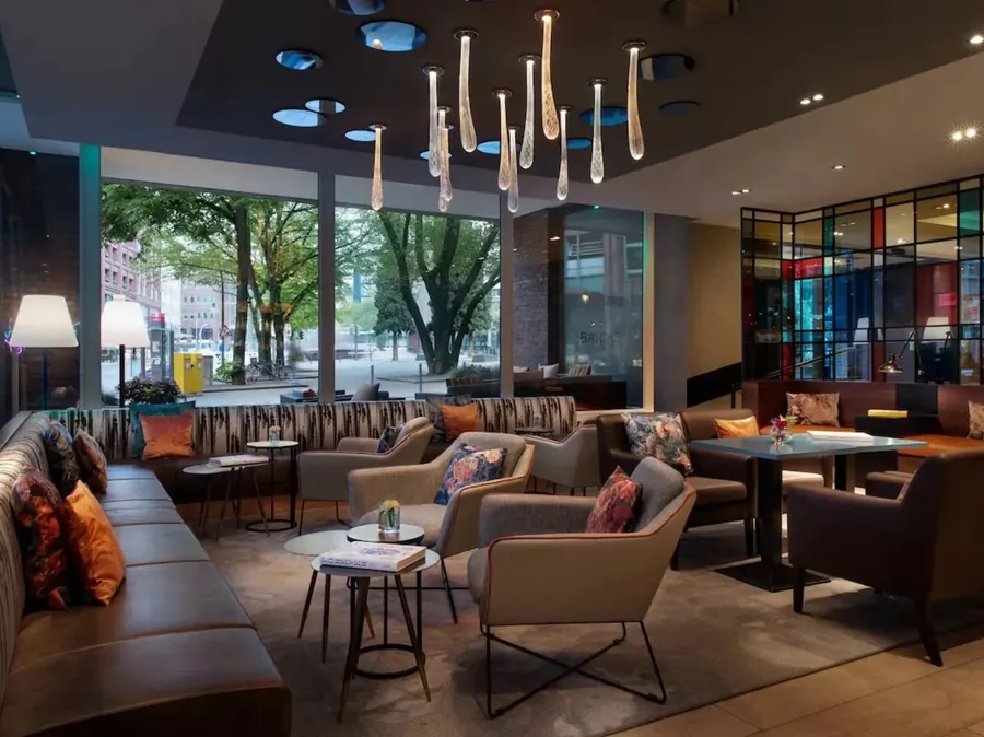 Hotel bar lounge with modern brass chandelier and plush seating
