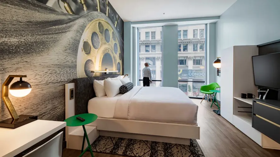 Boutique hotel king bedroom with expansive city views