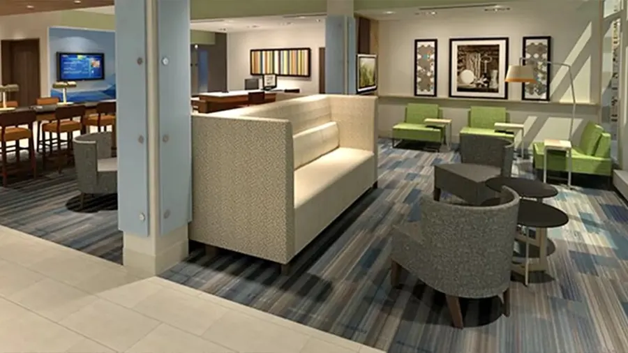 Hotel lobby lounge featuring high-back privacy banquettes and cocktail tables